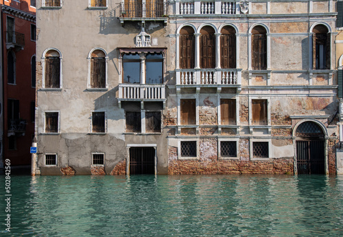Venice, Italy, 18 October, 2020. Navigating the Canals on a passenger boat during the high tide period, very high sea level, the water is submerging steps and doorways and almost touching the windows.