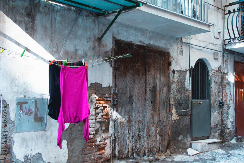 Naples, 25 April 2022. Close up shot of the typical laundered clothes hanging from the clotheslines in the picturesque narrow alleys of the Spanish Neighborhood (Quartieri Spagnoli). Naples, 25 April 2022. Close up shot of the typical laundered clothes hanging from the clotheslines in the picturesque narrow alleys of the Spanish Neighborhood (Quartieri Spagnoli).