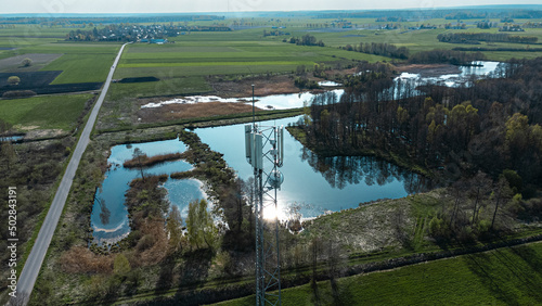 Adrone aerial view of Cellular Base Station. Green fields in the background photo