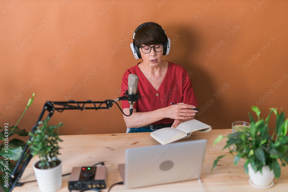 Middle-aged woman radio host making podcast recording for online show - broadcast and dj concept