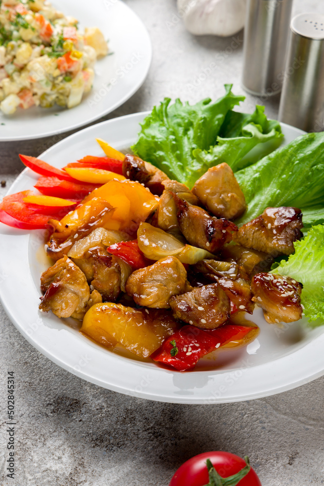 Pork in sweet and sour sauce with fried vegetables