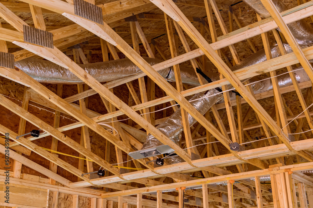 Installing air condition system for ceiling air ventilation and cleaning system pipes on the under construction new home Installing air condition system for ceiling air ventilation and cleaning system pipes on the under construction new home