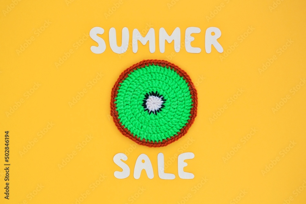 Fototapeta premium Slice of kiwi and lettering Summer sale on yellow background. Banner with percentage sign. Promotion of the poster sale or percent discount in the store. Mock up, top view, flatlay concept