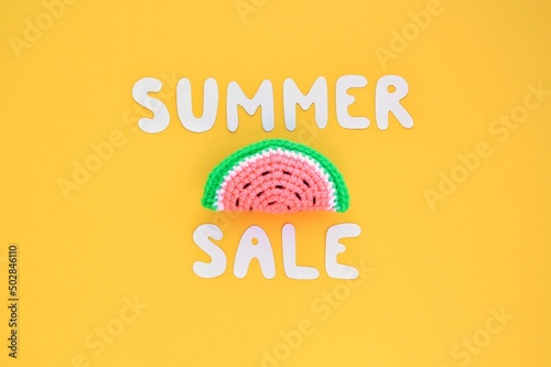 Slice of watermelon and lettering Summer sale on yellow background. Banner with percentage sign. Promotion of the poster sale or percent discount in the store. Mock up, top view, flatlay concept photo