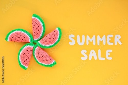 Slices of watermelon and lettering Summer sale on yellow background. Banner with percentage sign. Promotion of the poster sale or percent discount in the store. Mock up, top view, flatlay concept photo