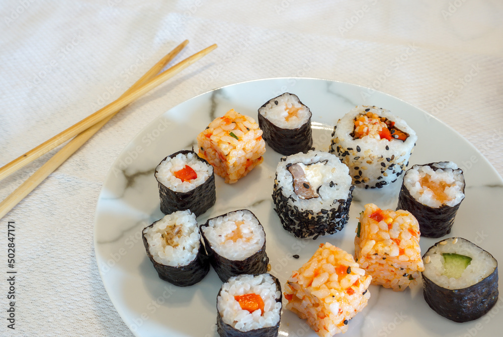 sushi and chopsticks food image. Tasty Japanese style food. Healthy and nutritious sushi rolls on plate. sushi and chopsticks food image. Tasty Japanese style food. Healthy and nutritious sushi rolls on plate.