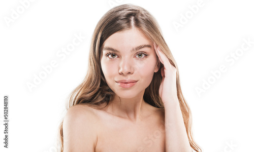 Smiling and touching her face while posing in studio