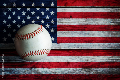 Leather Baseball on Rustic Wooden Background Painted With US Flag. United States is one of the world's top baseball nations.