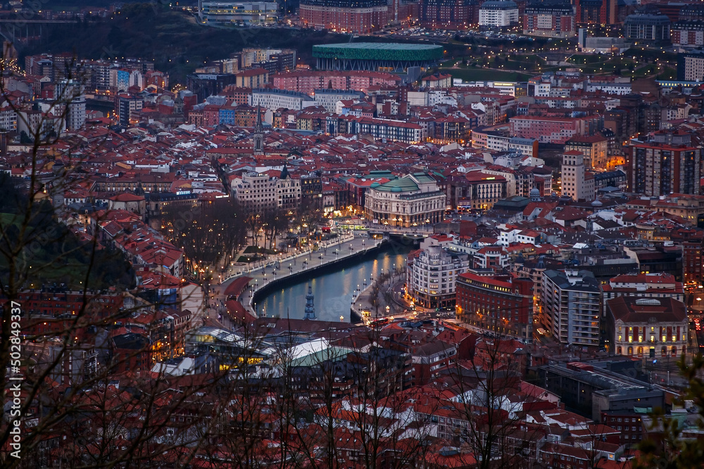 Aerial view on Bilbao center with red roofs and Nervion river.
