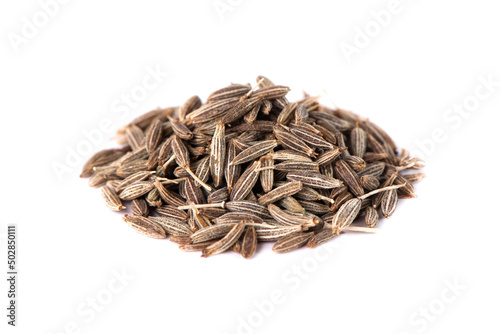 Dry seeds of cumin or zira. Cumin spice close-up on a white background.