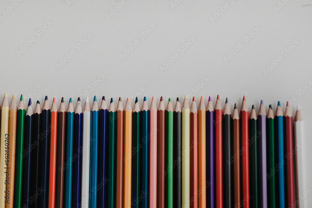Different colored pencils on a white table Different colored pencils on a white table