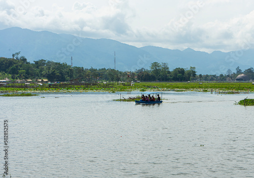 Tourists using raft enjoying Beautiful View of Bagendit Lake in Garut, West Java, Indonesia. Lake Bagendit is a popular tourist destination in Garut Regency. photo