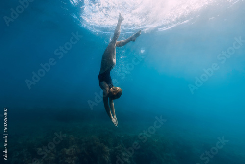 Woman dive in transparent sea. Freediving and beautiful lady in ocean