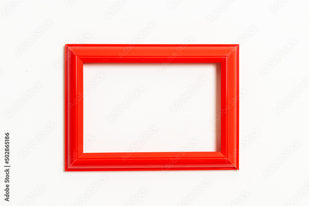 empty picture frame on white wall background empty picture frame on white wall background