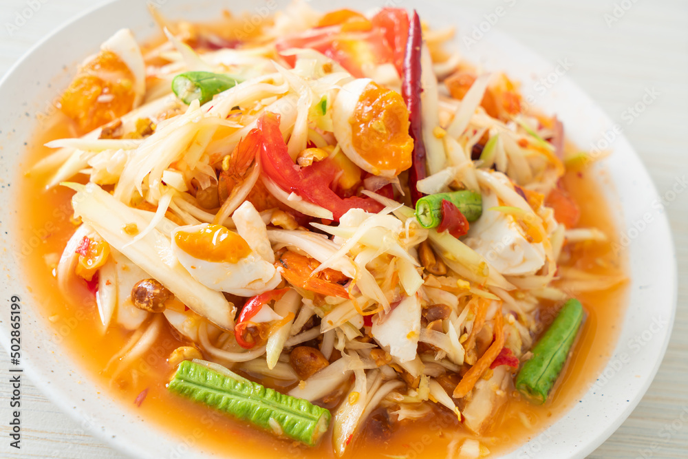 Som Tum - Thai Spicy green papaya salad with salty eggs Som Tum - Thai Spicy green papaya salad with salty eggs