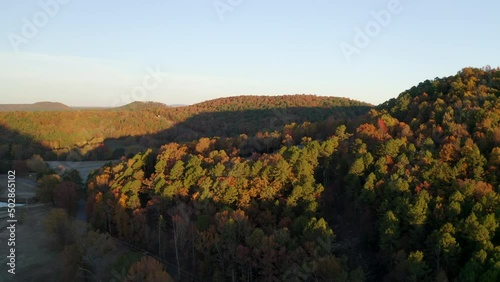 Aerial Forward Shot Of Autumn Trees In Forest On Hills Against Sky - Russellville, Arkansas photo