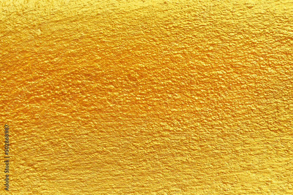 Concrete wall with gold yellow orange paint with embossed uneven seamless patterns for colorful background