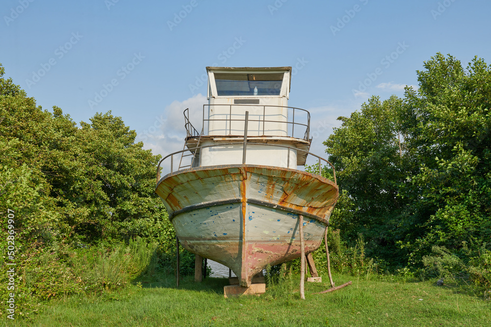 one abandoned ship stands in the sea in the bushes one abandoned ship stands in the sea in the bushes