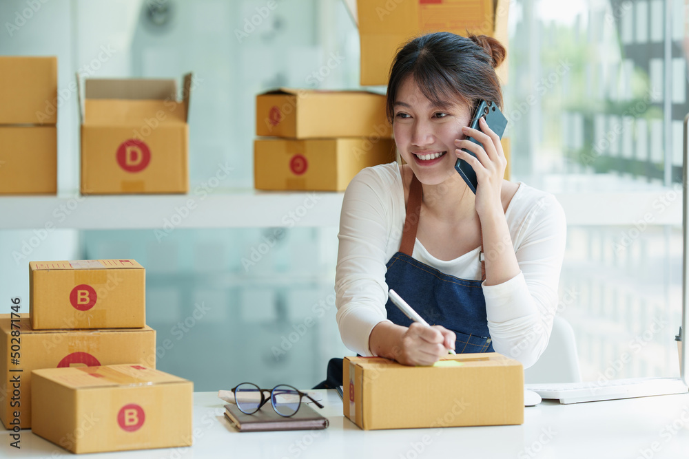 Young asian freelance packing boxes for commercial. SME e commerce concept. Young asian freelance packing boxes for commercial. SME e commerce concept.
