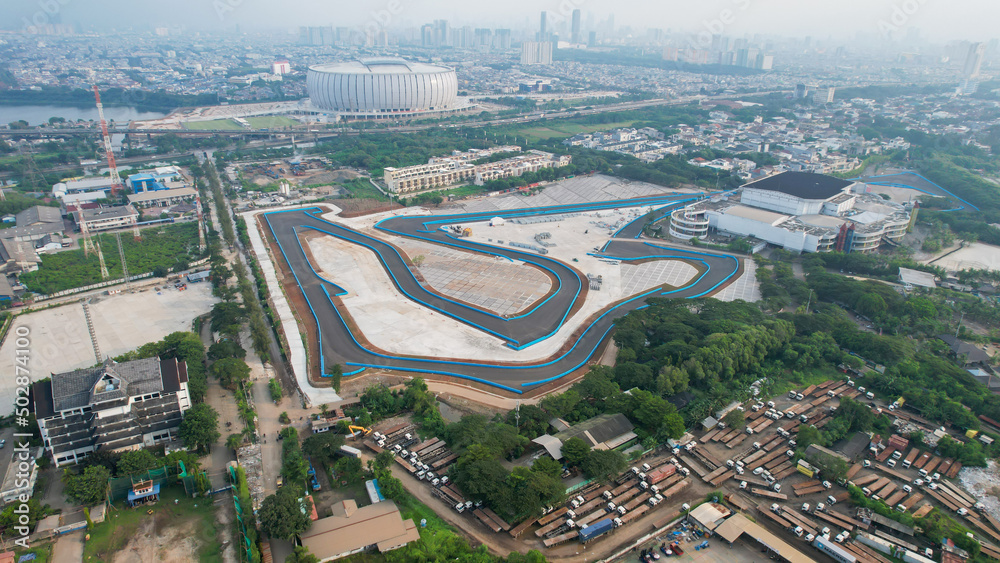Aerial view of the Beautiful scenery of Jakarta Formula E Circuit. with Jakarta cityscape background. Jakarta, Indonesia, May 6, 2022