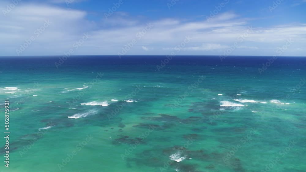 Blue ocean under a blue cloudy sky on a summer sunny day. Turquoise sea water with white crests off the tropical coast. Cruise. Holidays at sea. Blue ocean under a blue cloudy sky on a summer sunny day. Turquoise sea water with white crests off the tropical coast. Cruise. Holidays at sea.