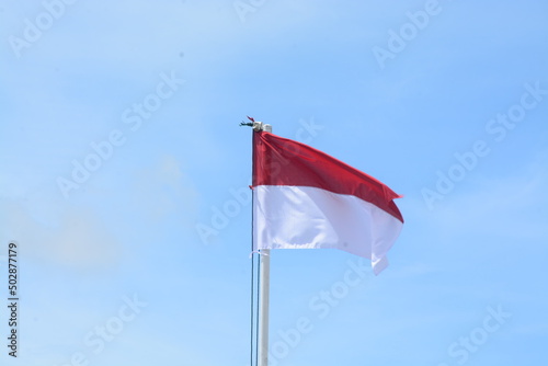 the flag of indonesia, the unitary state of the republic of indonesia under the concept of independence, blue sky. (bendera indonesia, negara kesatuan republik indonesia dengan konsep kemerdekaan)