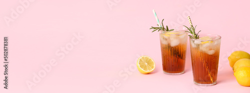 Panel kuchenny z motywem Glasses of tasty iced black tea with lemon on pink background with space for text