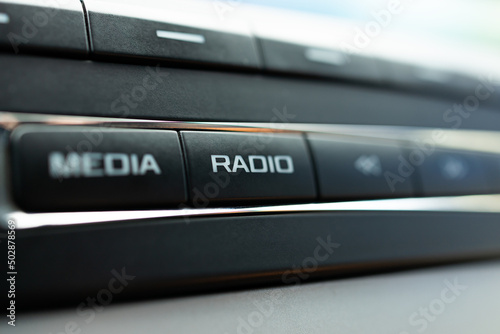 car audio media control panel. macro. auto sound repair service. radio button close up