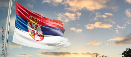 Serbianational flag cloth fabric waving on the sky - Image photo