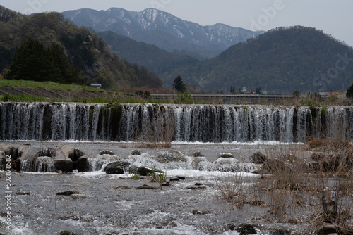 Mogami river with greens and trees. Natural water of melting snow from Mt. Zao 