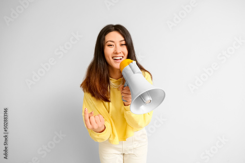 Young Asian woman with mega...
