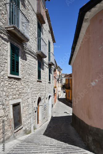 Fototapeta Naklejka Na Ścianę i Meble -  A narrow street between the old houses of Morcone, a village in the province of Benevento, Italy.