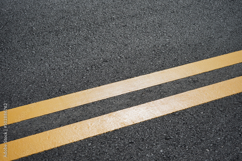 Fototapeta premium Blurred image, paved road and yellow traffic markings