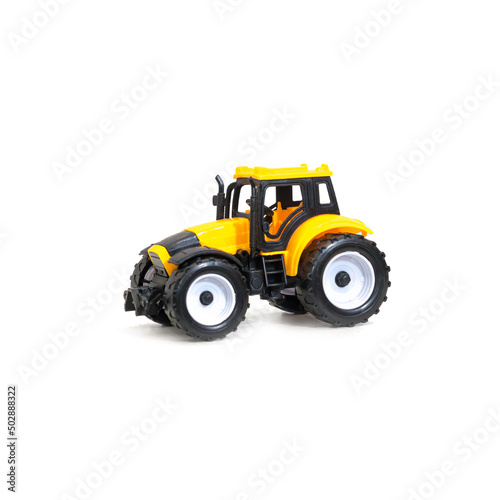 Children's toy tractor yellow on white background