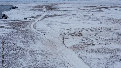 Wallpaper Mural Person on quad bike driving through vast open snow covered Iceland landscape, aerial Torontodigital.ca