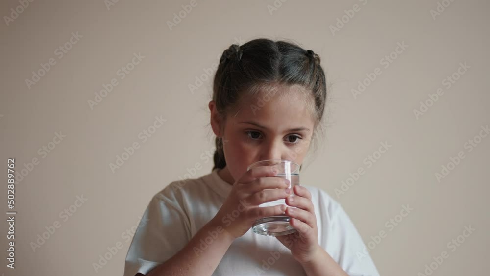 child drinking water. little girl in the kitchen drinks water from a glass cup. problem of shortage of drinking water in the world concept. kid drinking clean water from a lifestyle glass child drinking water. little girl in the kitchen drinks water from a glass cup. problem of shortage of drinking water in the world concept. kid drinking clean water from a lifestyle glass