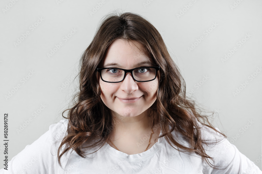 Woman wearing glasses. Businesswoman smiling and looking at camera.