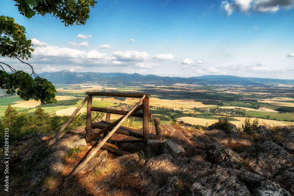 Lonely empty bench with beautiful view on summer countryside on hill called Ondrasovska skala, Slovakia Lonely empty bench with beautiful view on summer countryside on hill called Ondrasovska skala, Slovakia