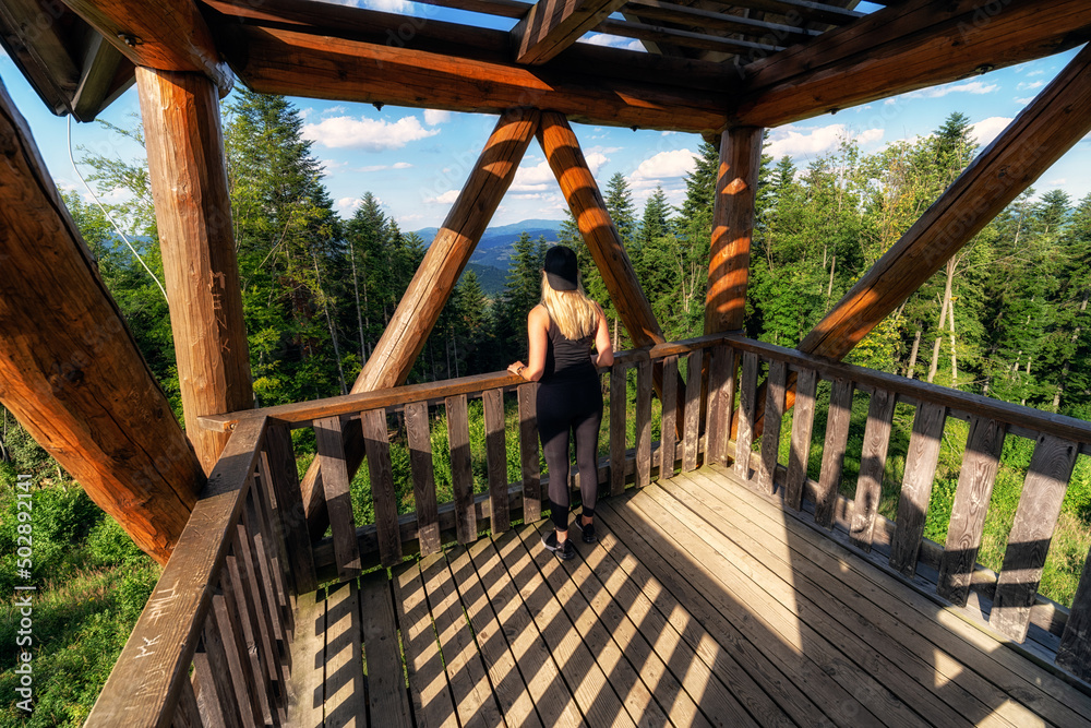 Tourist girl in wooden lookout on hill tabor in Slovakia Tourist girl in wooden lookout on hill tabor in Slovakia