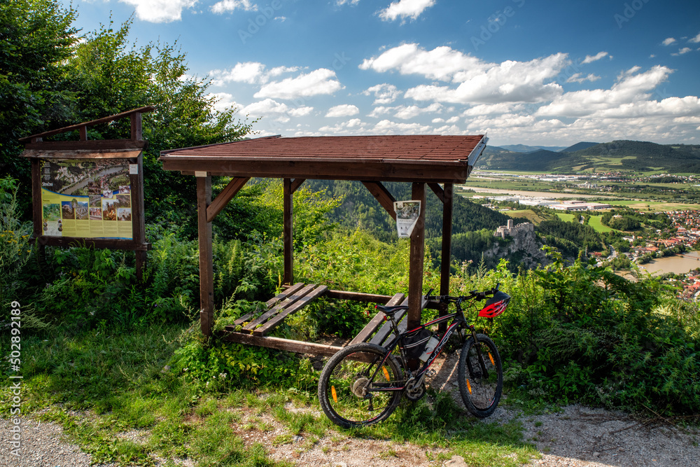 Bike and beautiful view on summer  country. Strecno castle at background