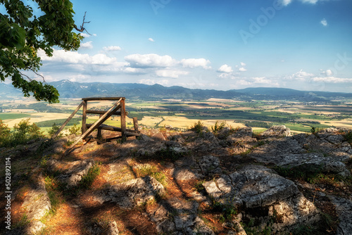 Lonely empty bench with beautiful view on summer countryside on hill called Ondrasovska skala, Slovakia © Jaroslav Moravcik
