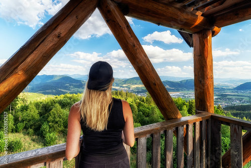 Fényképezés Tourist girl in wooden lookout on hill tabor in Slovakia