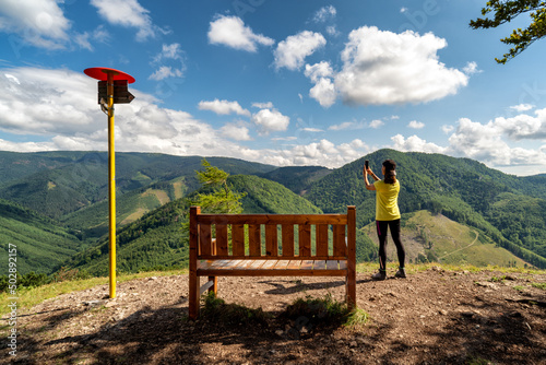 Woman and tourist attraction bench on top of the hill Cipcie in Slovakia photo