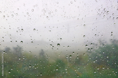 Rain water dew drop on mirror window car textured   can see tree view outside