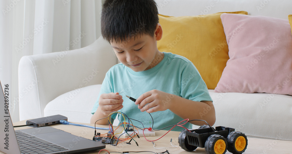 Little Boy Playing Car Game On Computer At Home Stock Photo