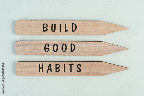 The words build good habits are standing on arrows, change lifestyle, healthy and positive attidude, motivation concept