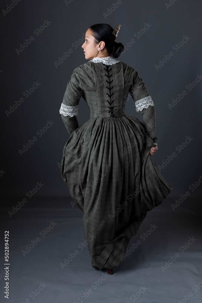A working class Victorian couple standing together against a studio backdrop A working class Victorian couple standing together against a studio backdrop