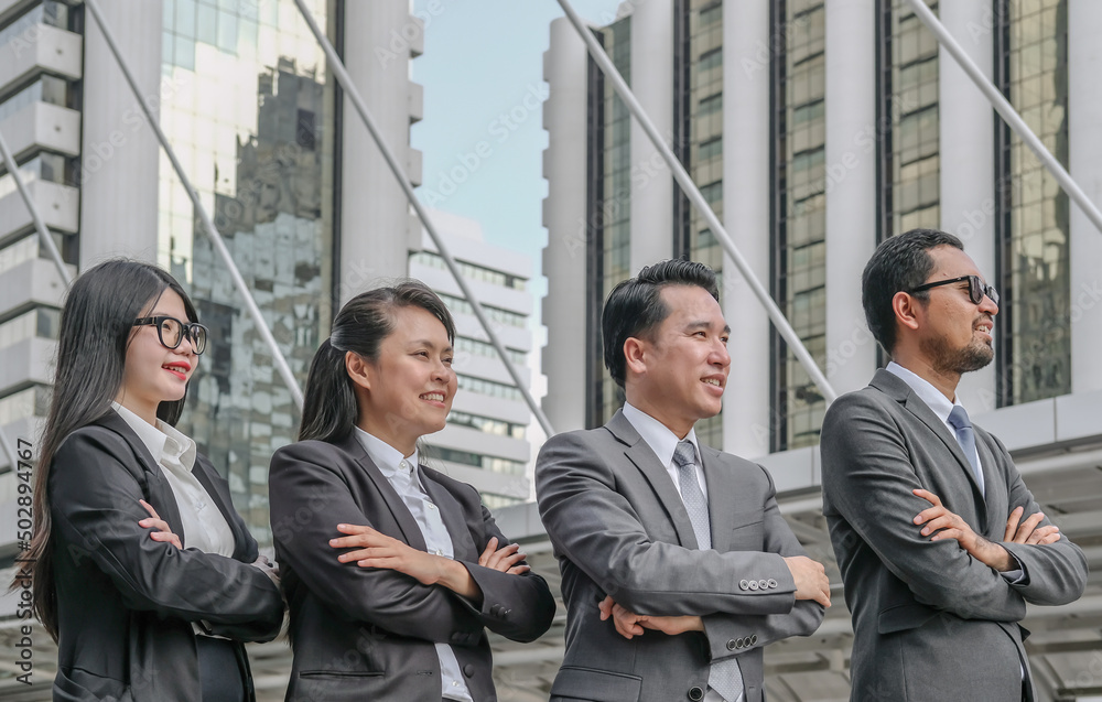 Professional asian business team standing arms crossed with confidence smiling in city background. Professional asian business team standing arms crossed with confidence smiling in city background.