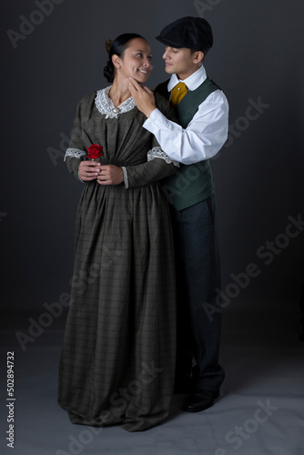 A working class Victorian couple standing together against a studio backdrop