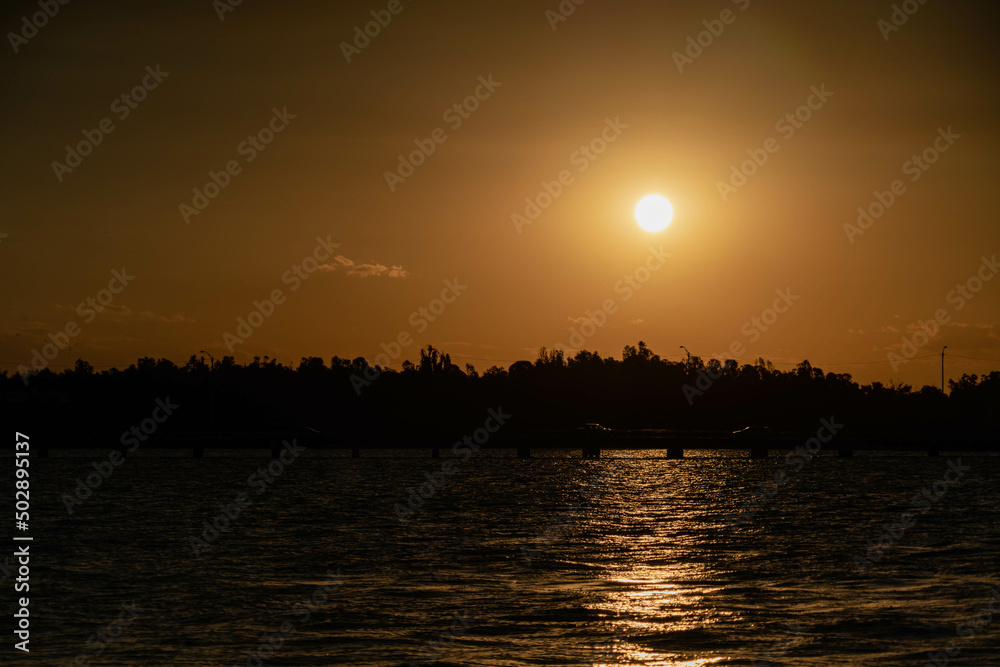 Naklejka premium sunset over the river